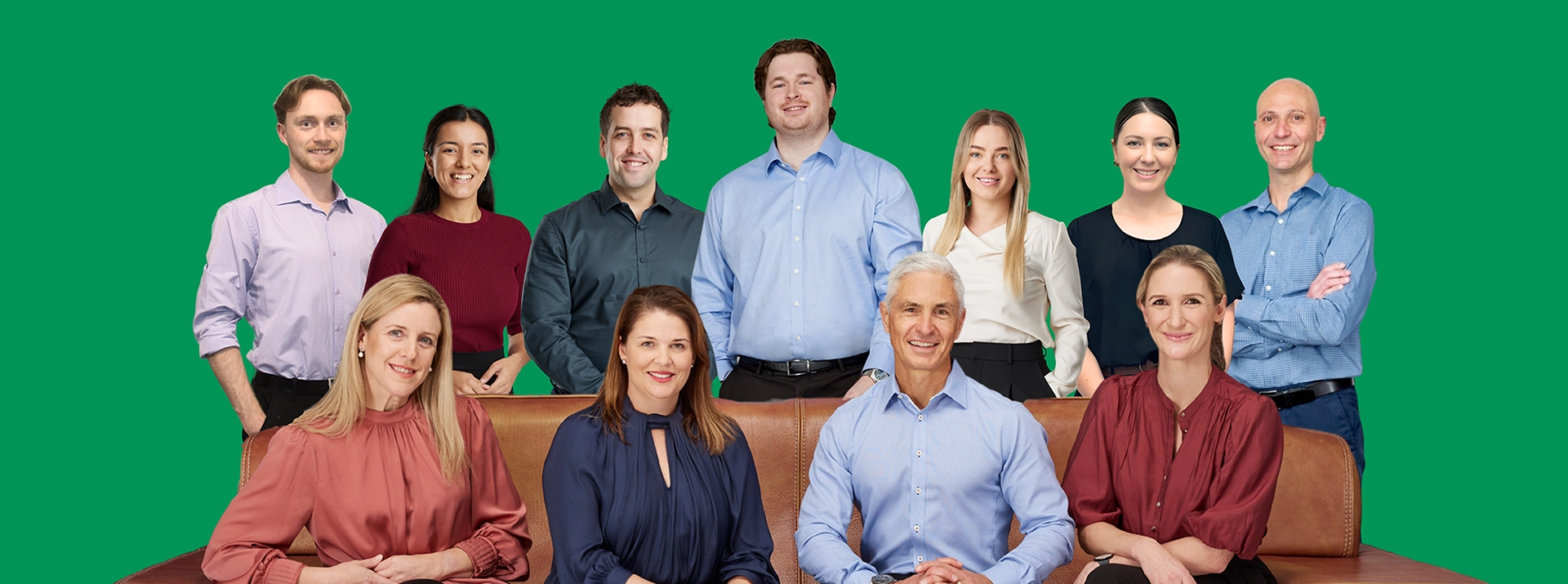 A team of eleven Peak Podiatry professionals, some sitting on a couch and others standing behind them.
