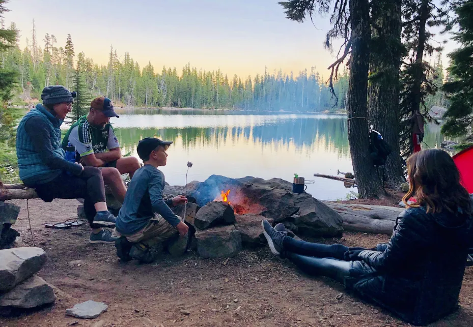 Australian students socializing around a campfire at AmeriCamp AU summer camp in USA.