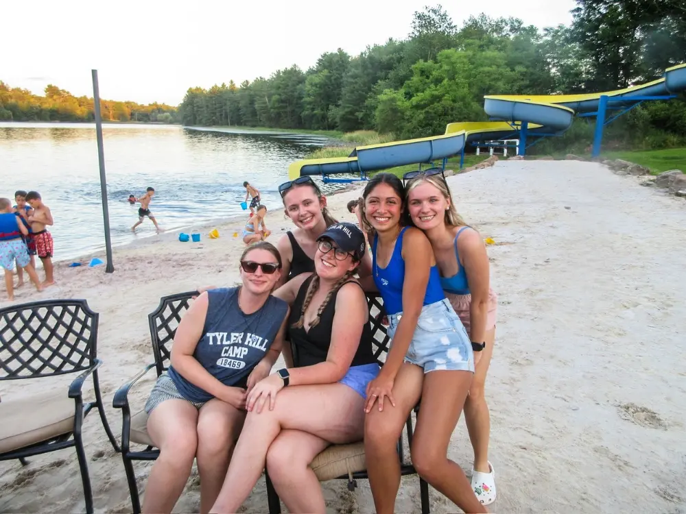 A group of friends bonding on the beach at AmeriCamp AU summer camp in USA.