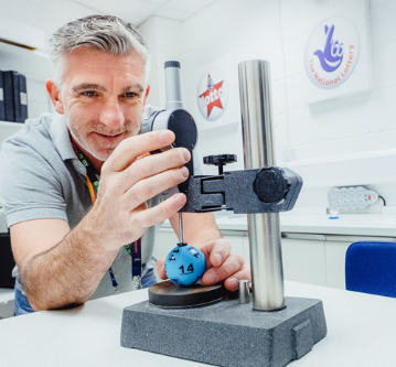 An audience at an event clapping and cheering enthusiastically. The crowd looks engaged, with some people laughing and smiling while applauding.