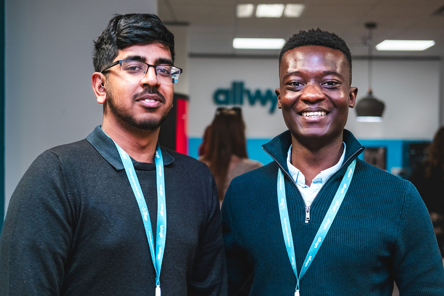 An audience at an event clapping and cheering enthusiastically. The crowd looks engaged, with some people laughing and smiling while applauding.