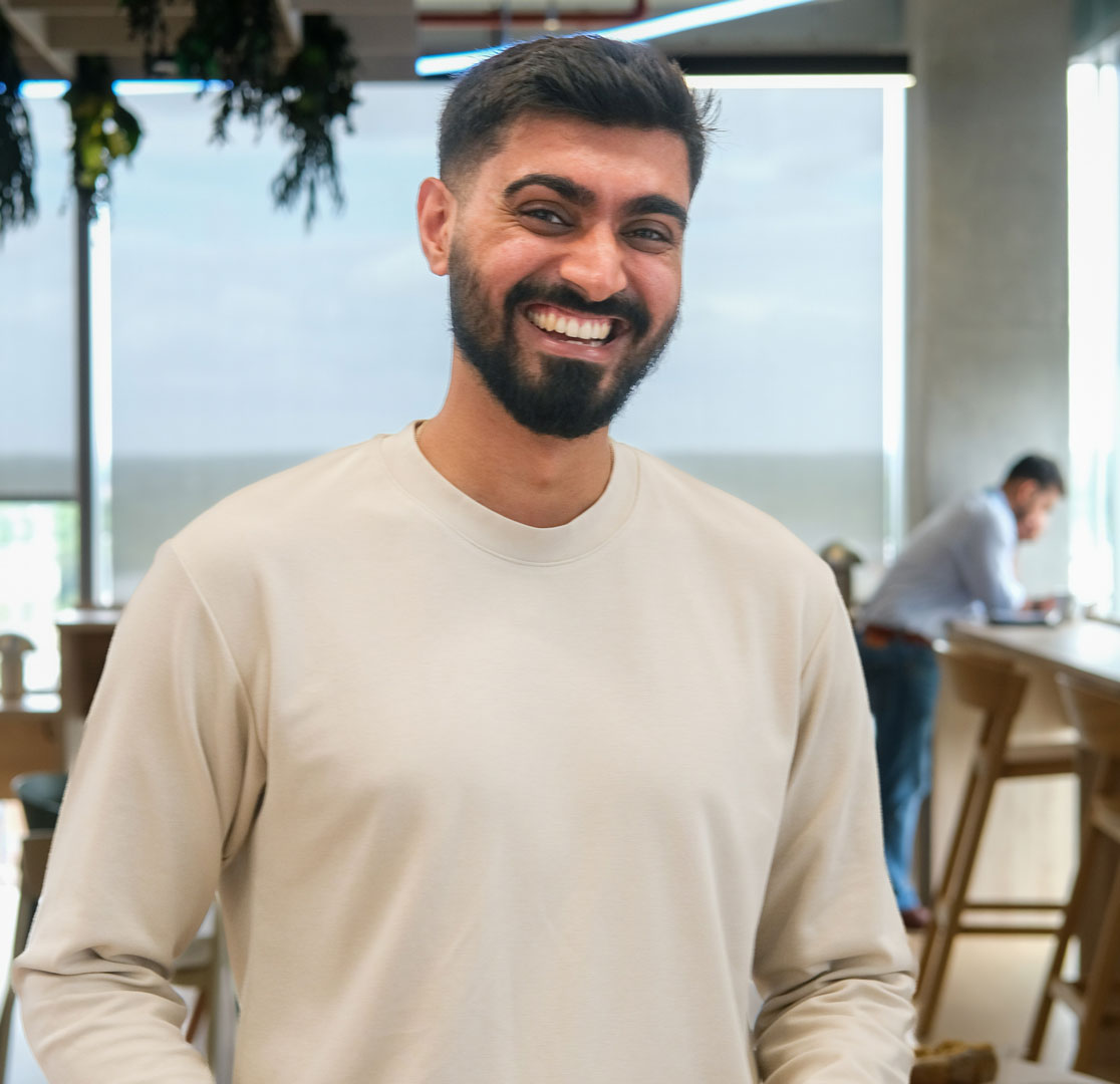 An audience at an event clapping and cheering enthusiastically. The crowd looks engaged, with some people laughing and smiling while applauding.