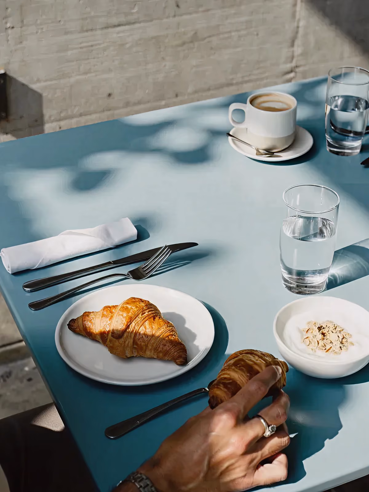 Croissant served on a plate at a café table