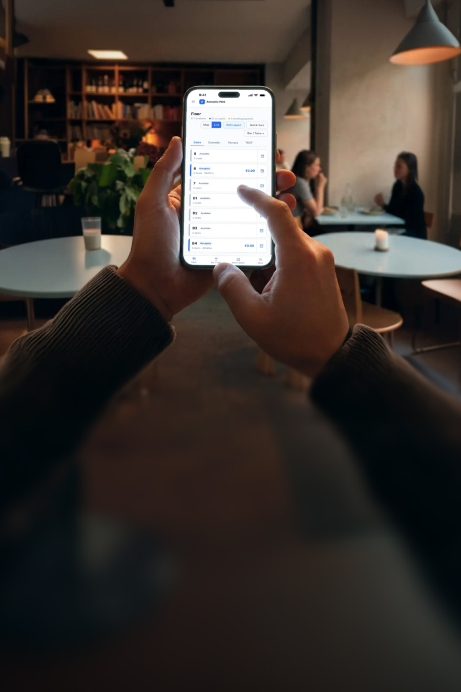 Restaurant staff taking an order on the Amenitiz POS app on a phone