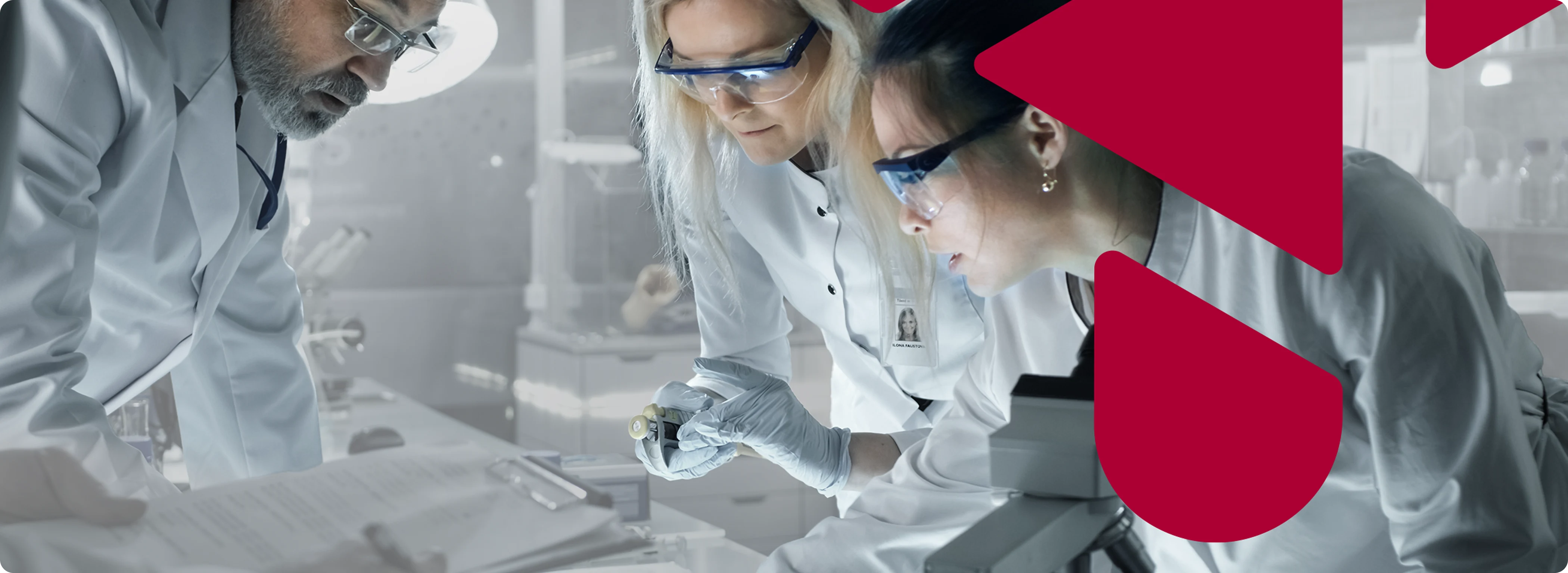 A group of people looking at laboratory equipment.