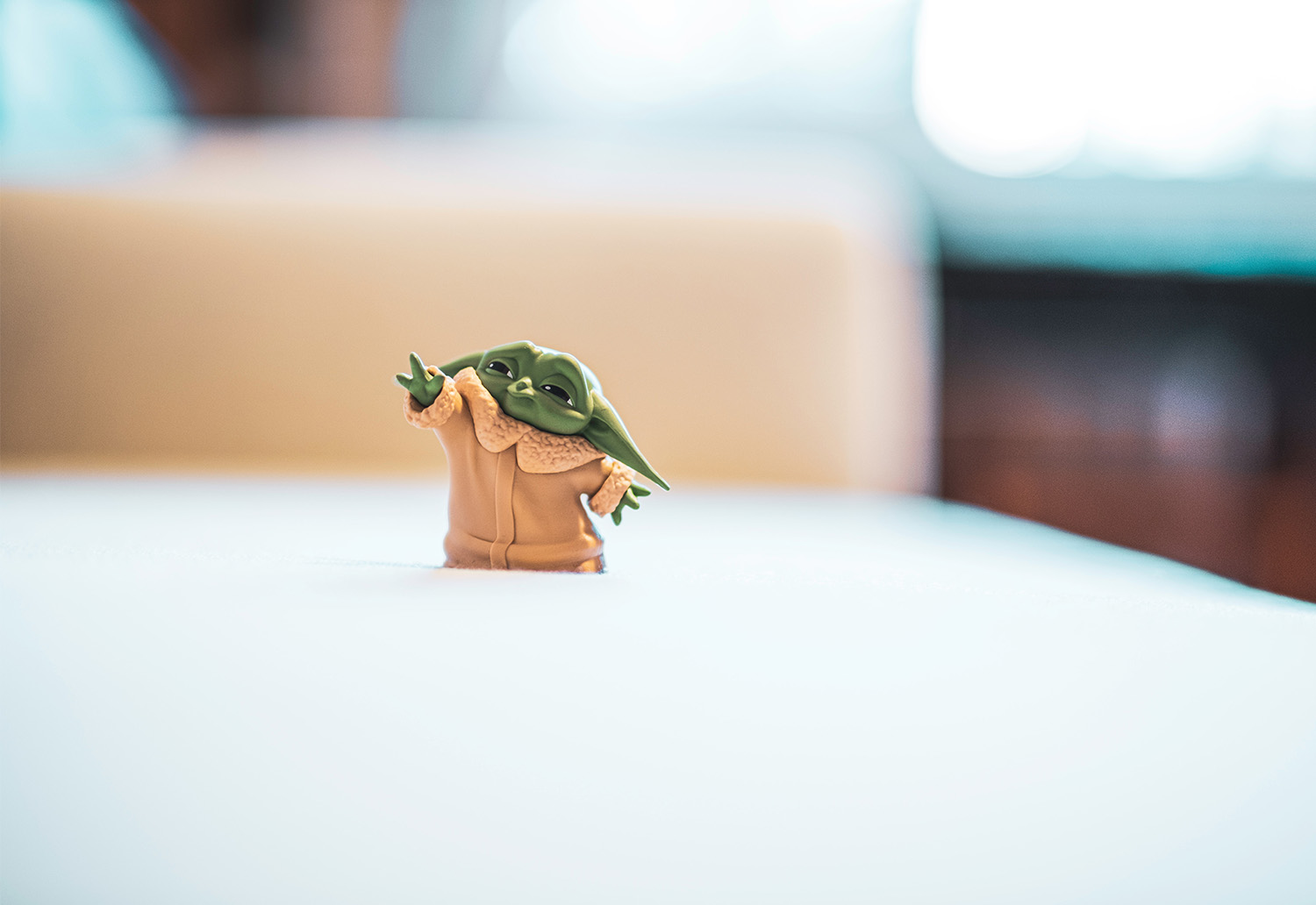 A tiny model of Yoda with his arm in the air