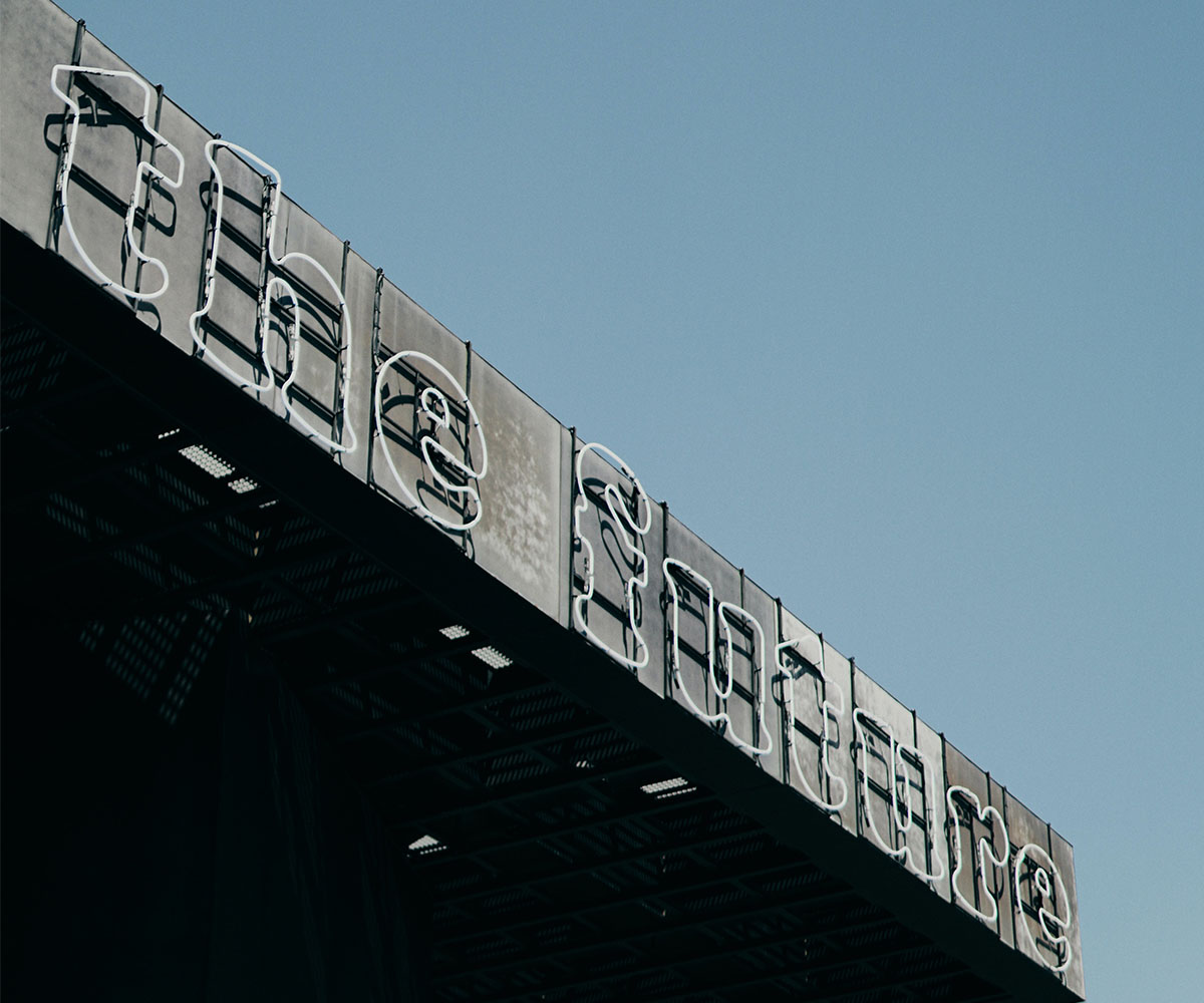 A sign on the side of a building that says 'the future'.