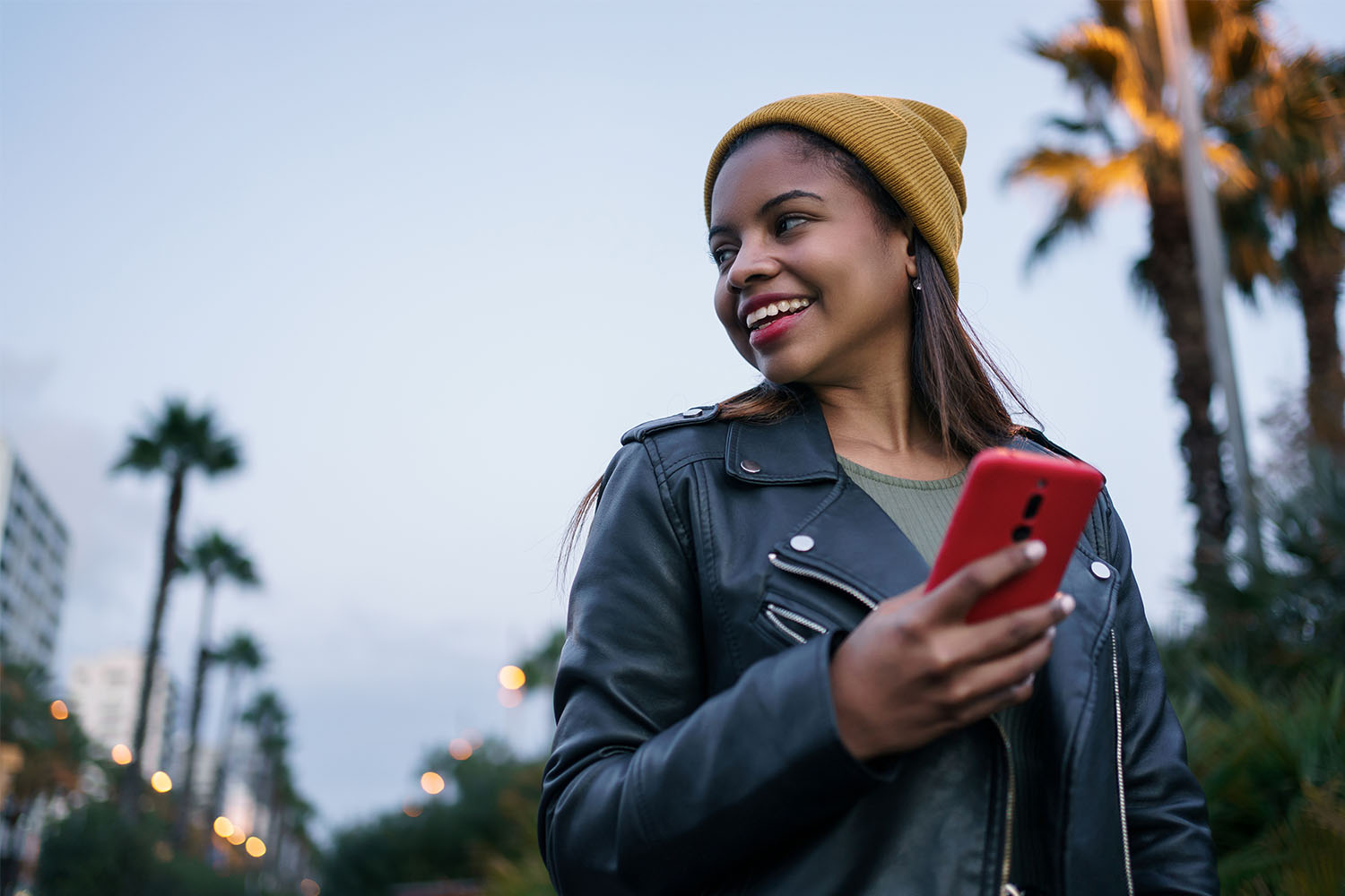 Girl holding her smartphone smiling