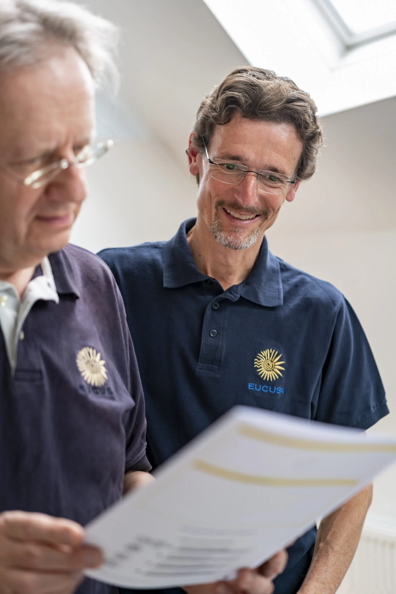Uwe Baco and Martin Ploderer are looking at a questionnaire from EUCUSA.