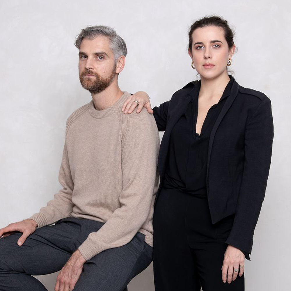 Wype Founders: Two people facing the camera in a studio environment, one sat and the other standing. 