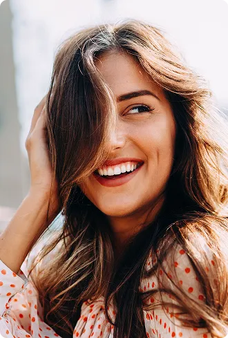 Beautiful young woman smiling with beautiful teeth showing