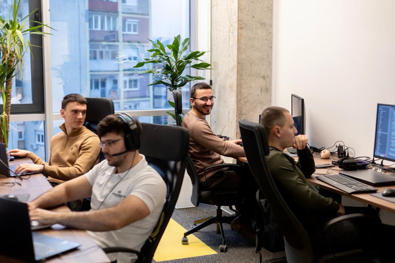 Four engineers sitting at their desks and thinking
