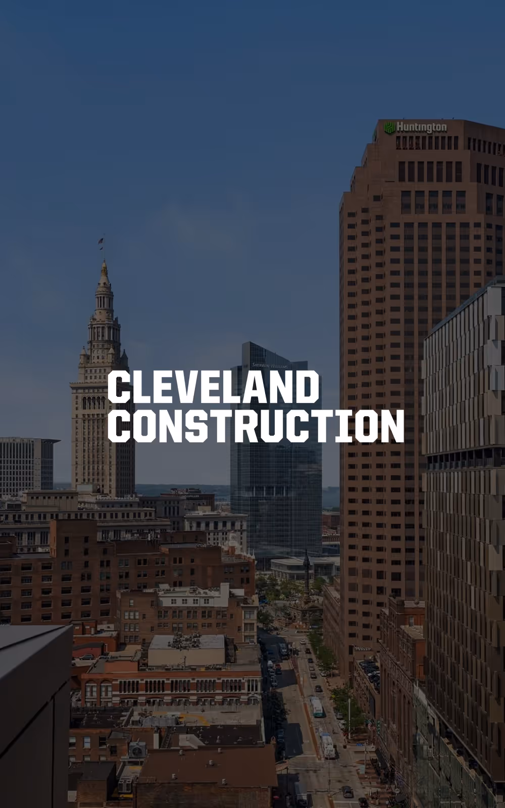 Downtown Cleveland skyline with prominent buildings and street view under a clear blue sky, with the text Cleveland Construction overlayed.