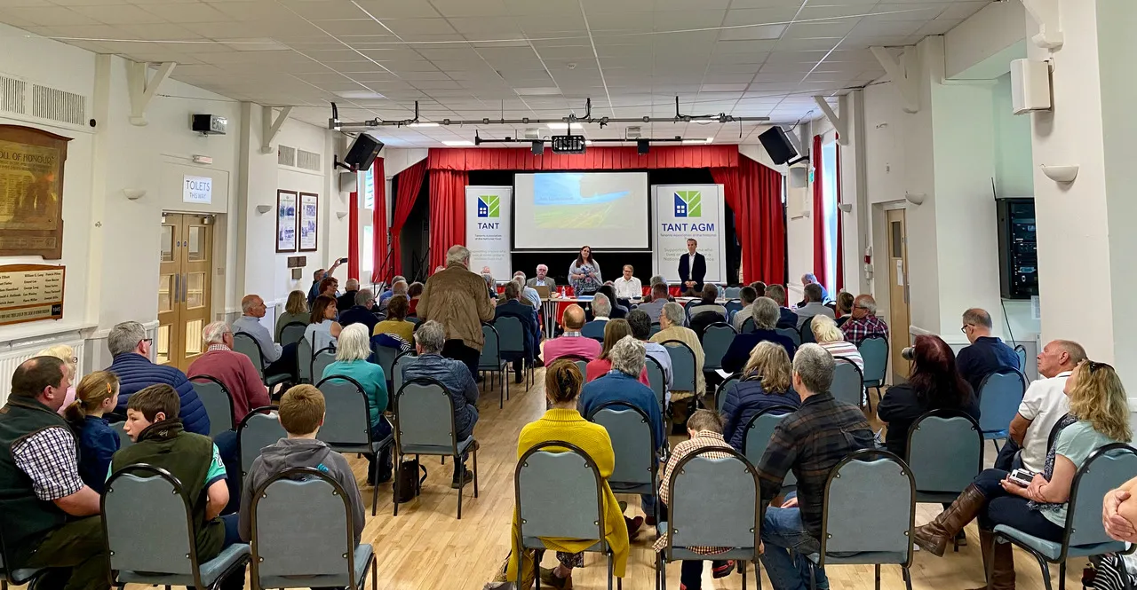 TANT AGM meeting with audience seated in community hall with stage