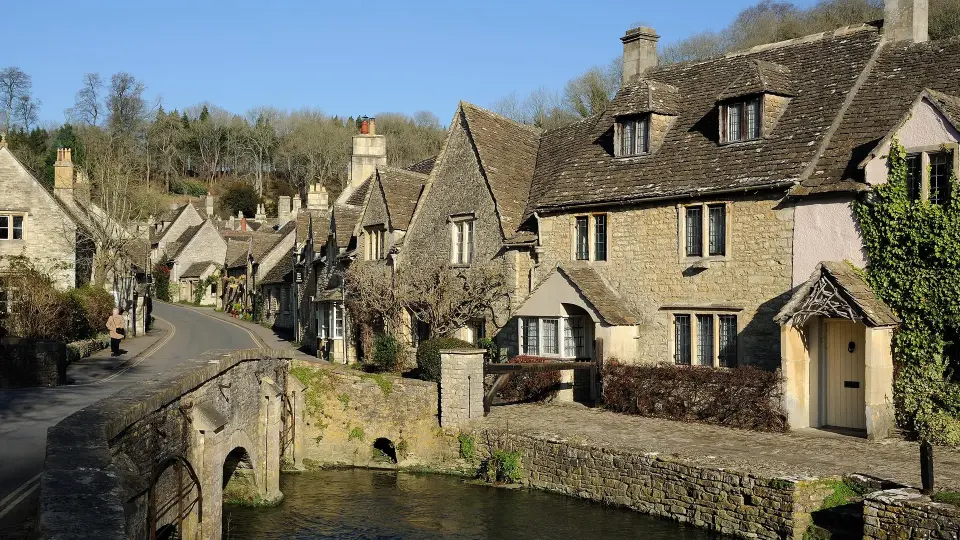 Charming stone cottages by a stream in a picturesque English village