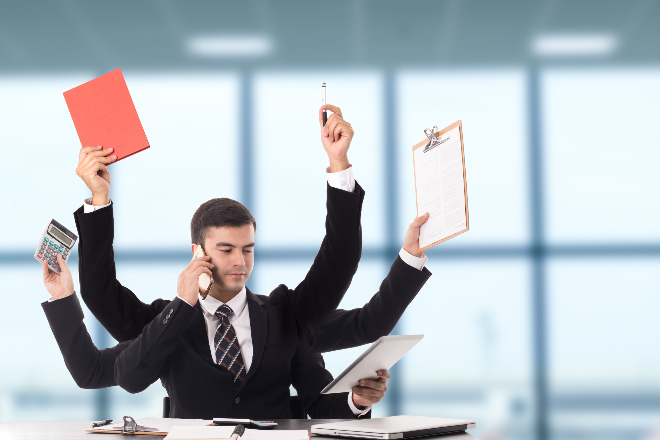 Multitasking business professional – IT Hawaii managing diverse IT tasks including support, planning, and communication