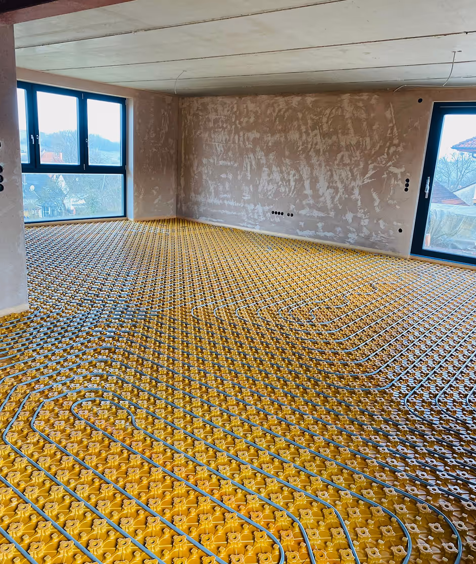 Moderne Fußbodenheizung auf gelber Noppenplatte in großem Wohnraum – AG Estriche Heilbronn