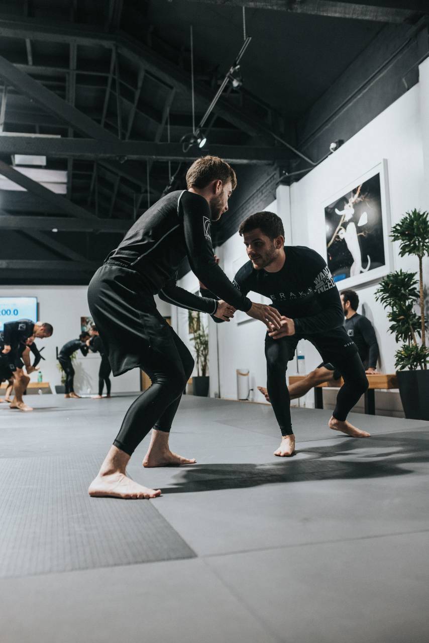 Guys practicing jiu jitsu