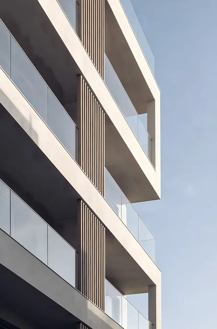 Modern building facade with glass railings and vertical wooden slats under clear sky.