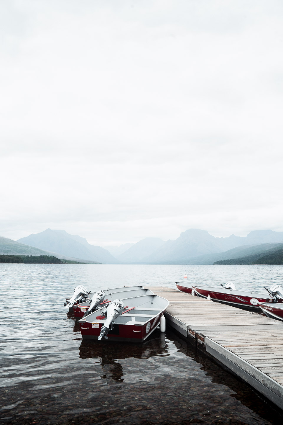 Boats and dock in lake at Glacier National Park
