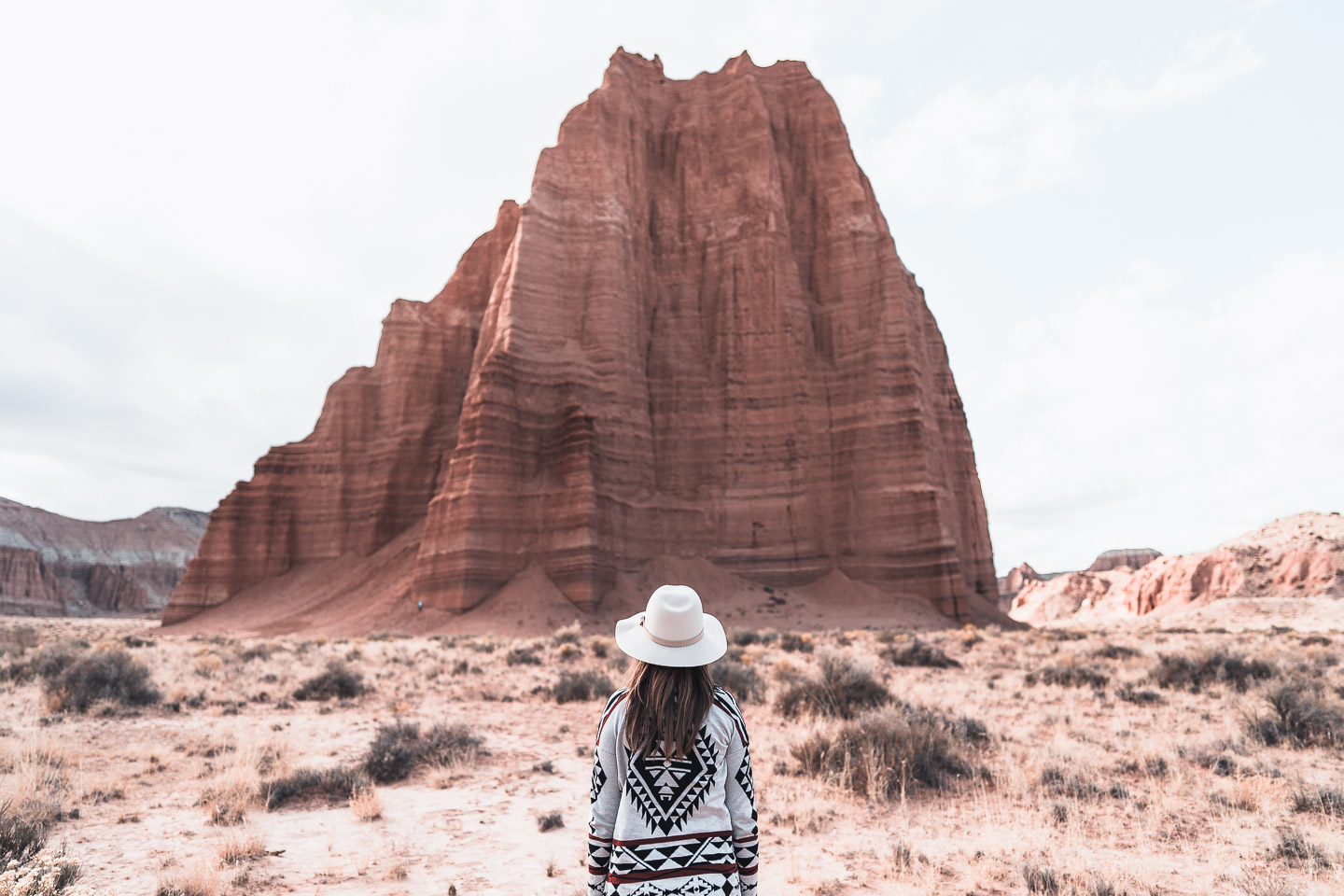 Woman standing near rock formation in remote Utah