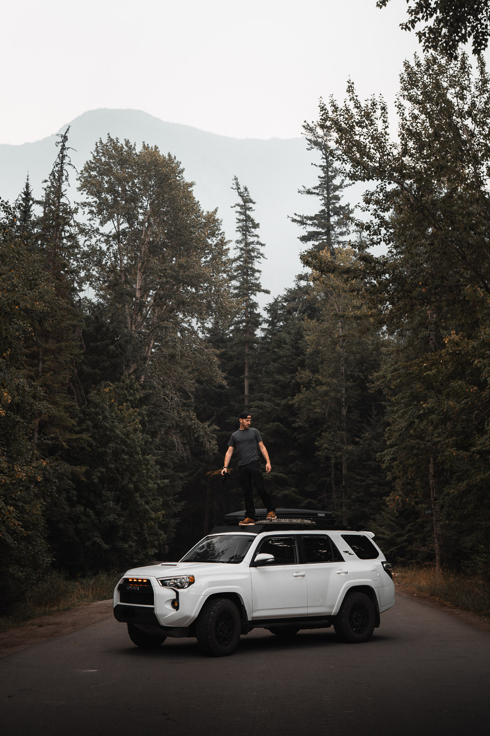 Man standing on Toyota 4Runner in Glacier National Park