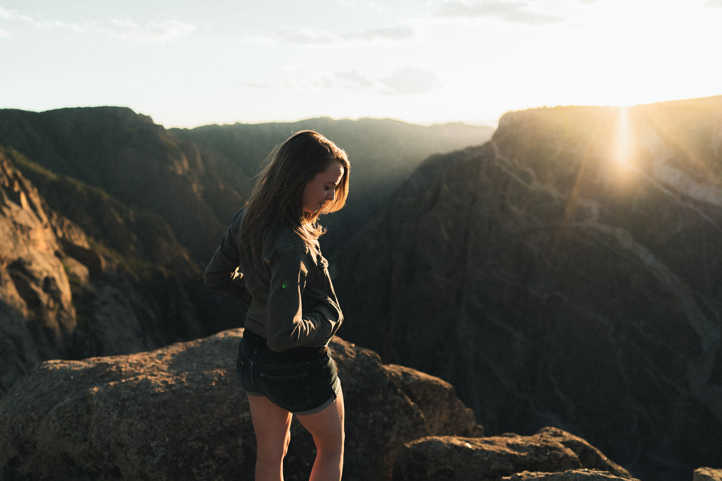 Woman near canyon at sunset