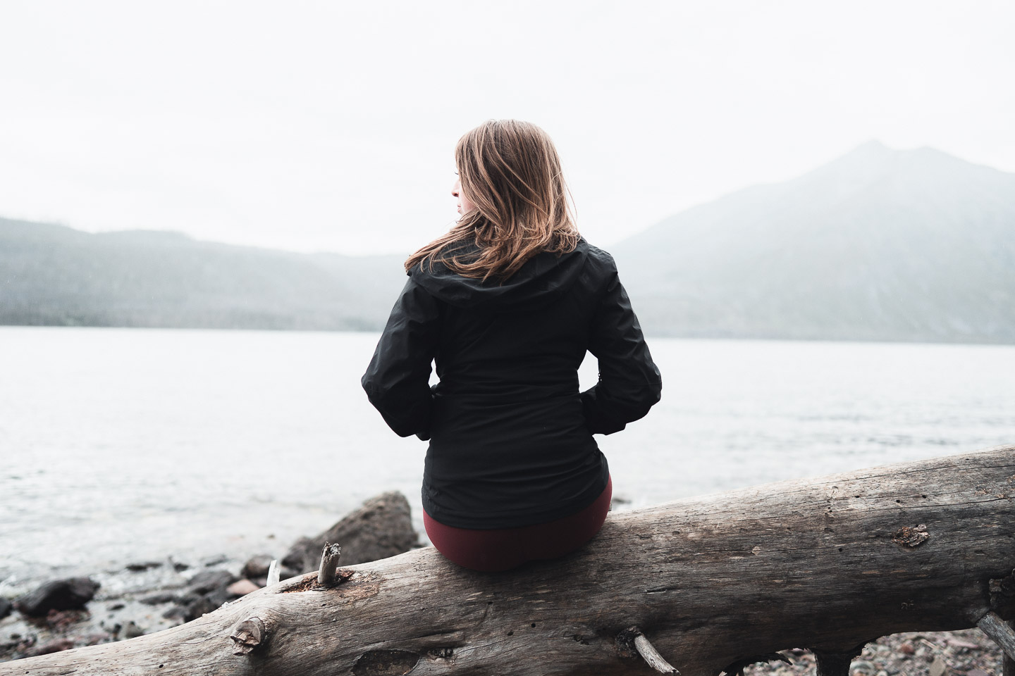 Woman sitting by lake in Montana