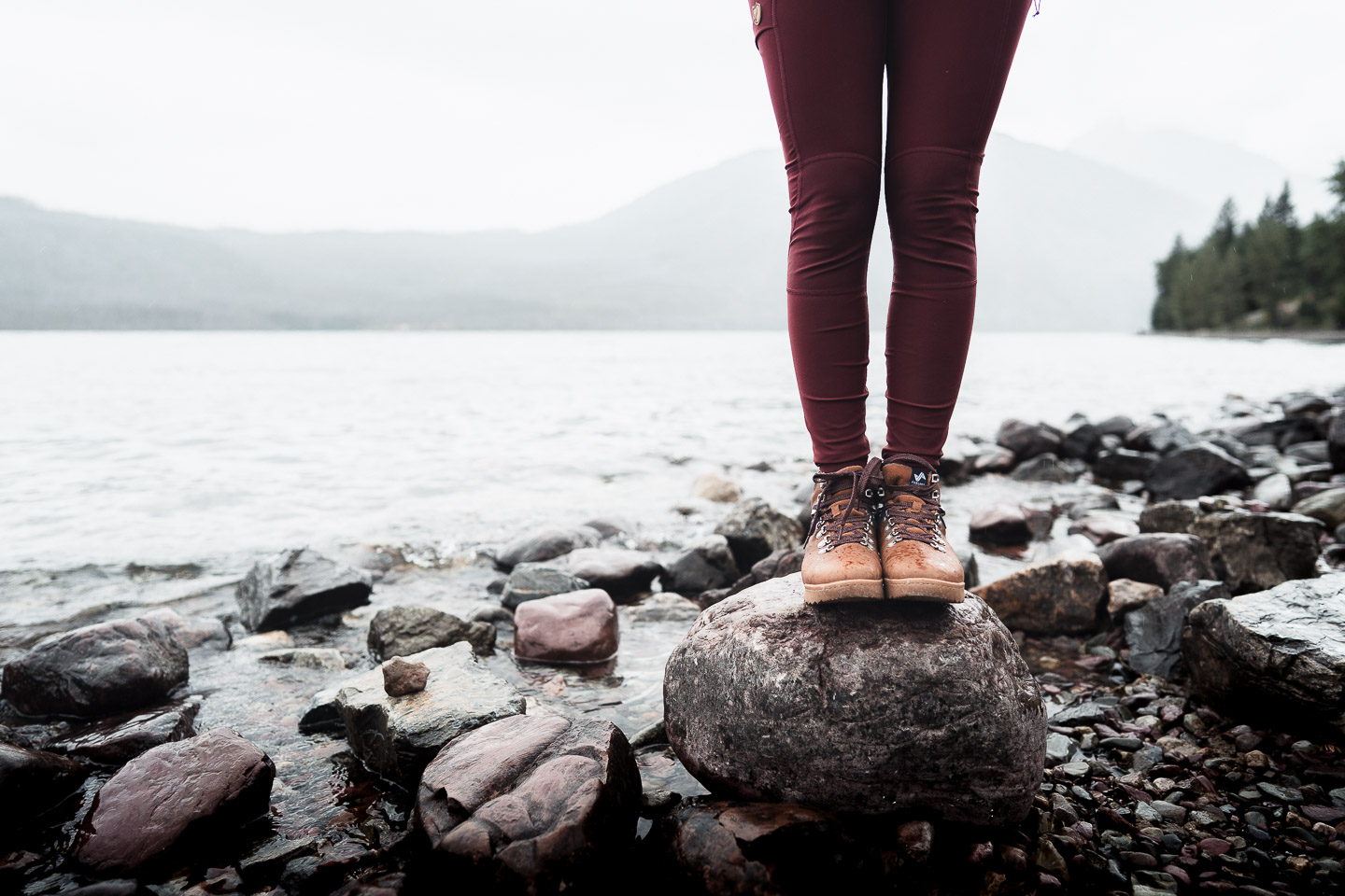 Woman standing by lake in Glacier National Park