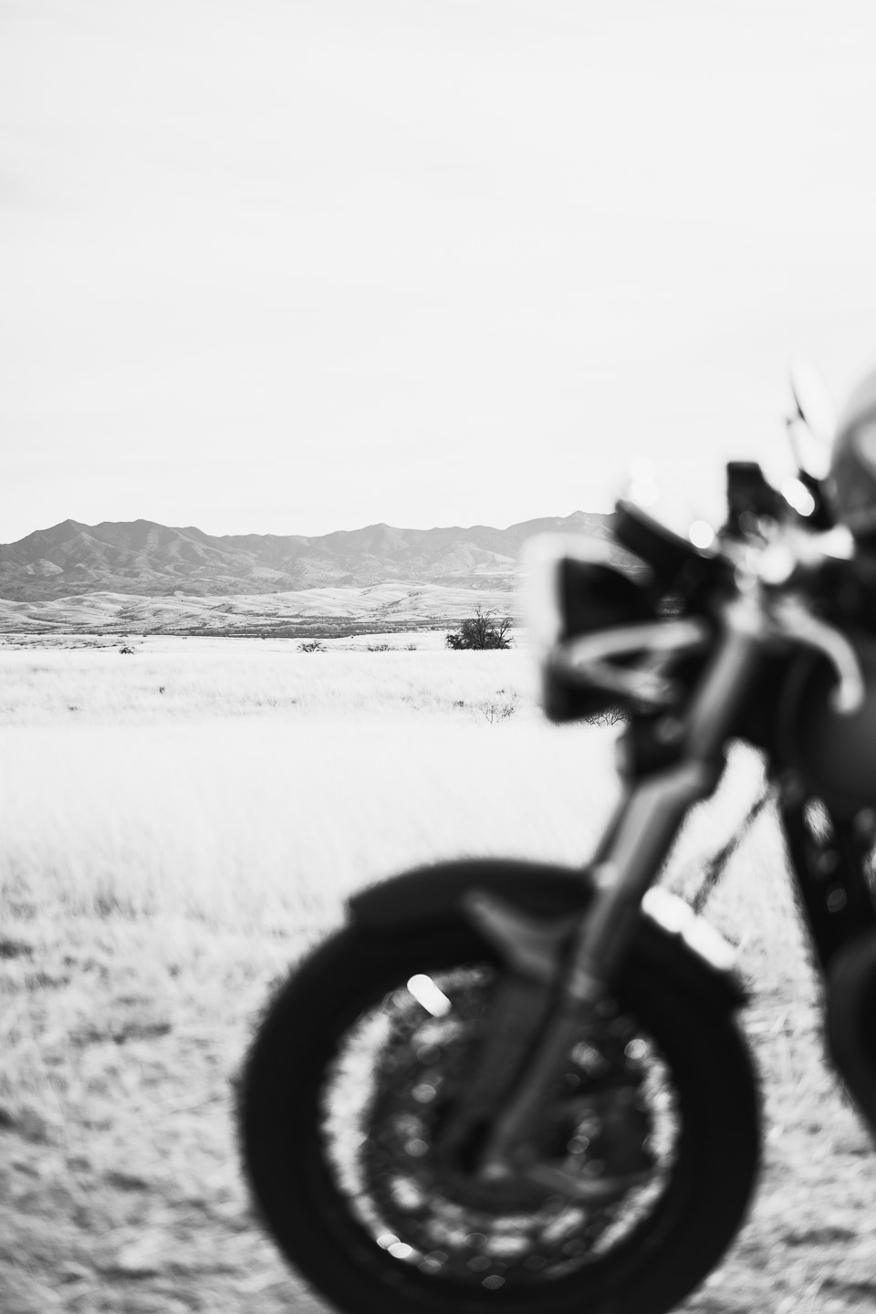 Landscape of mountains with Triumph motorcycle in foreground