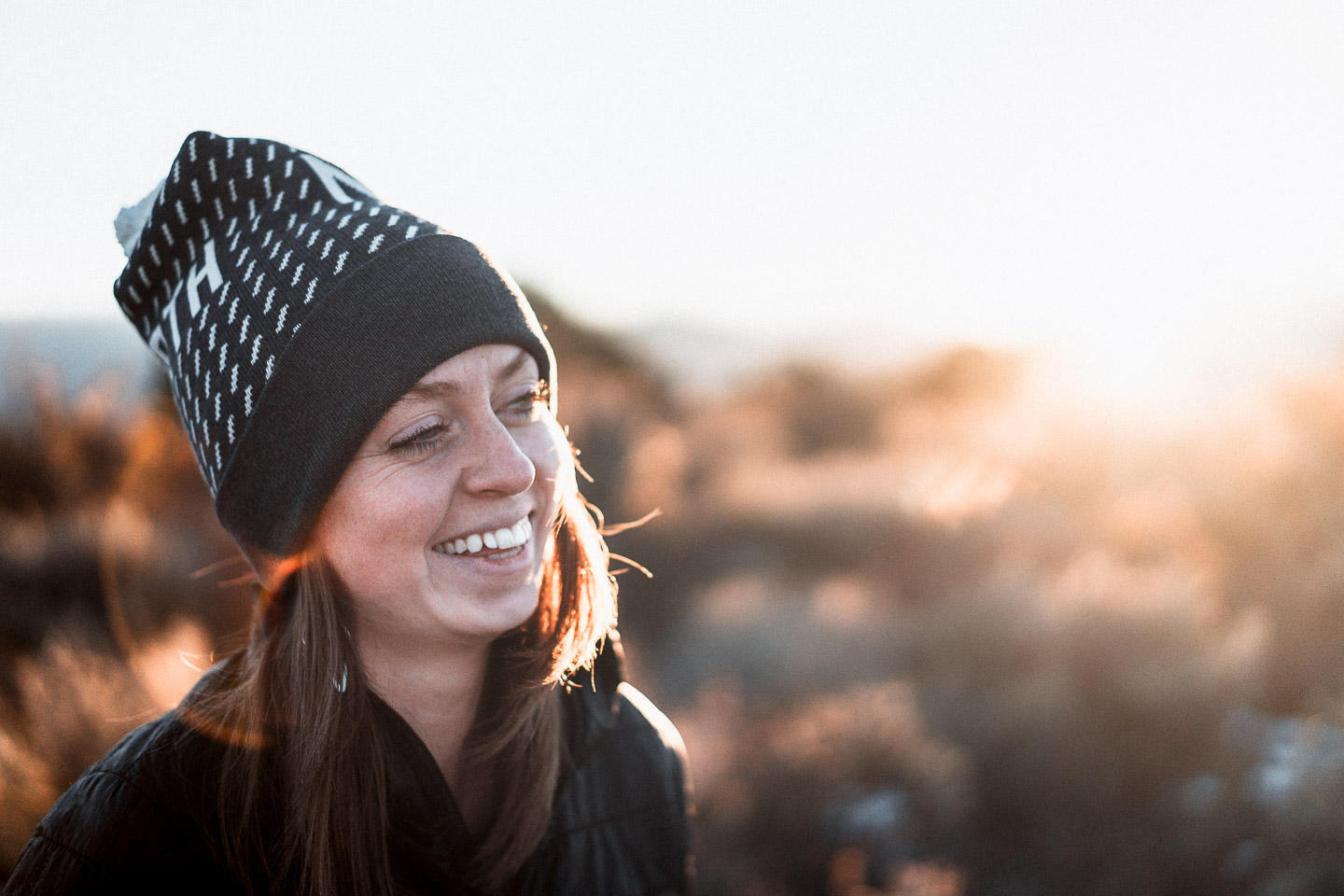 Portrait of woman smiling at sunset