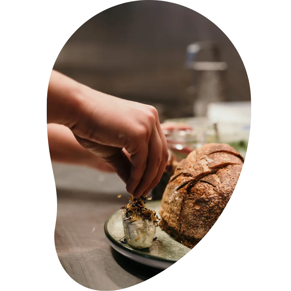 A dish with bread being prepared in the kitchen