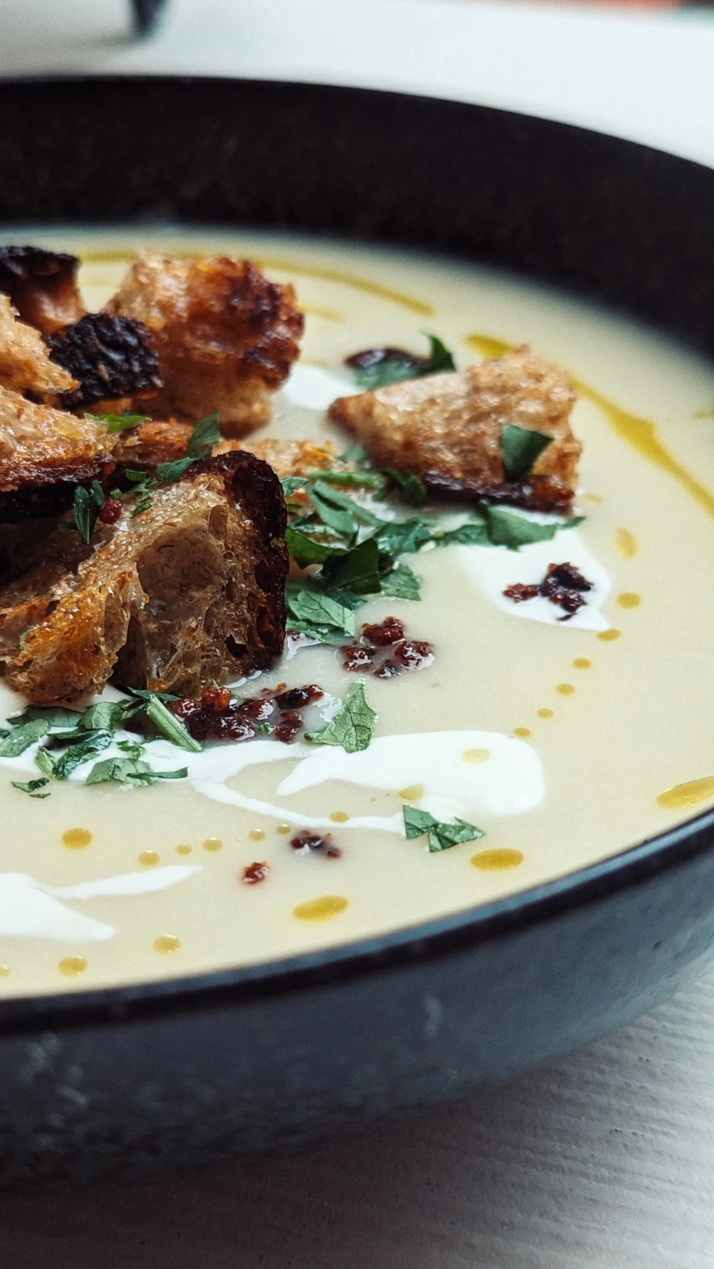 A soup with bread and herbs
