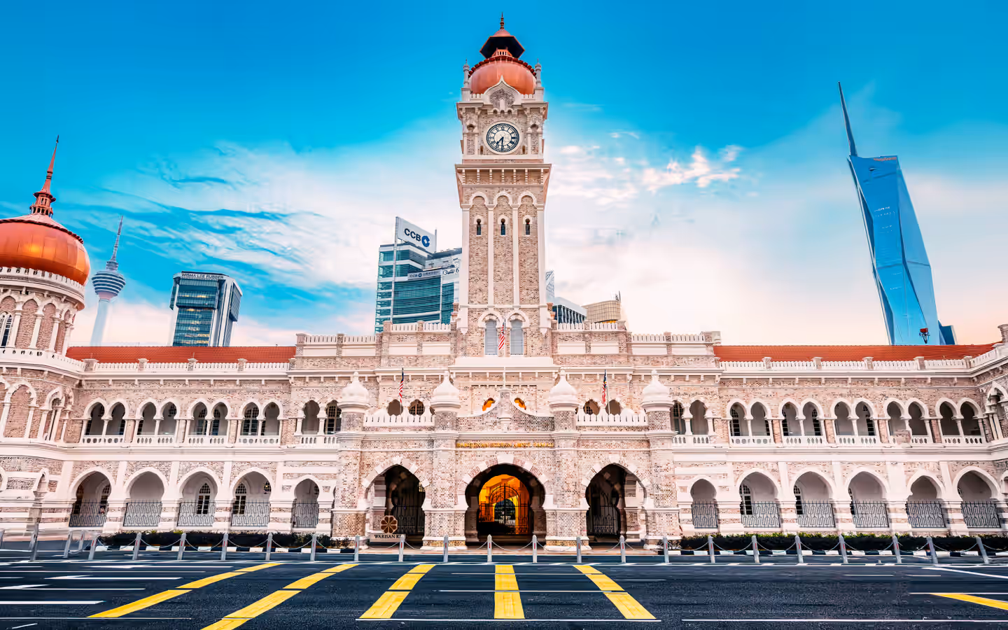 The iconic Sultan Abdul Samad Building against a clear sky in Kuala Lumpur, Malaysia.