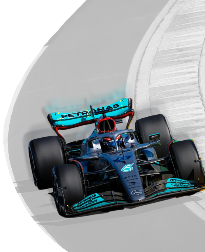Colorful F1 car on a faded, greyscale course
