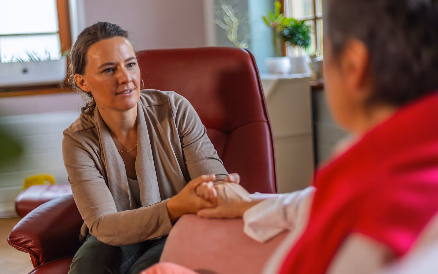 Ragena hält Hand der Patientin