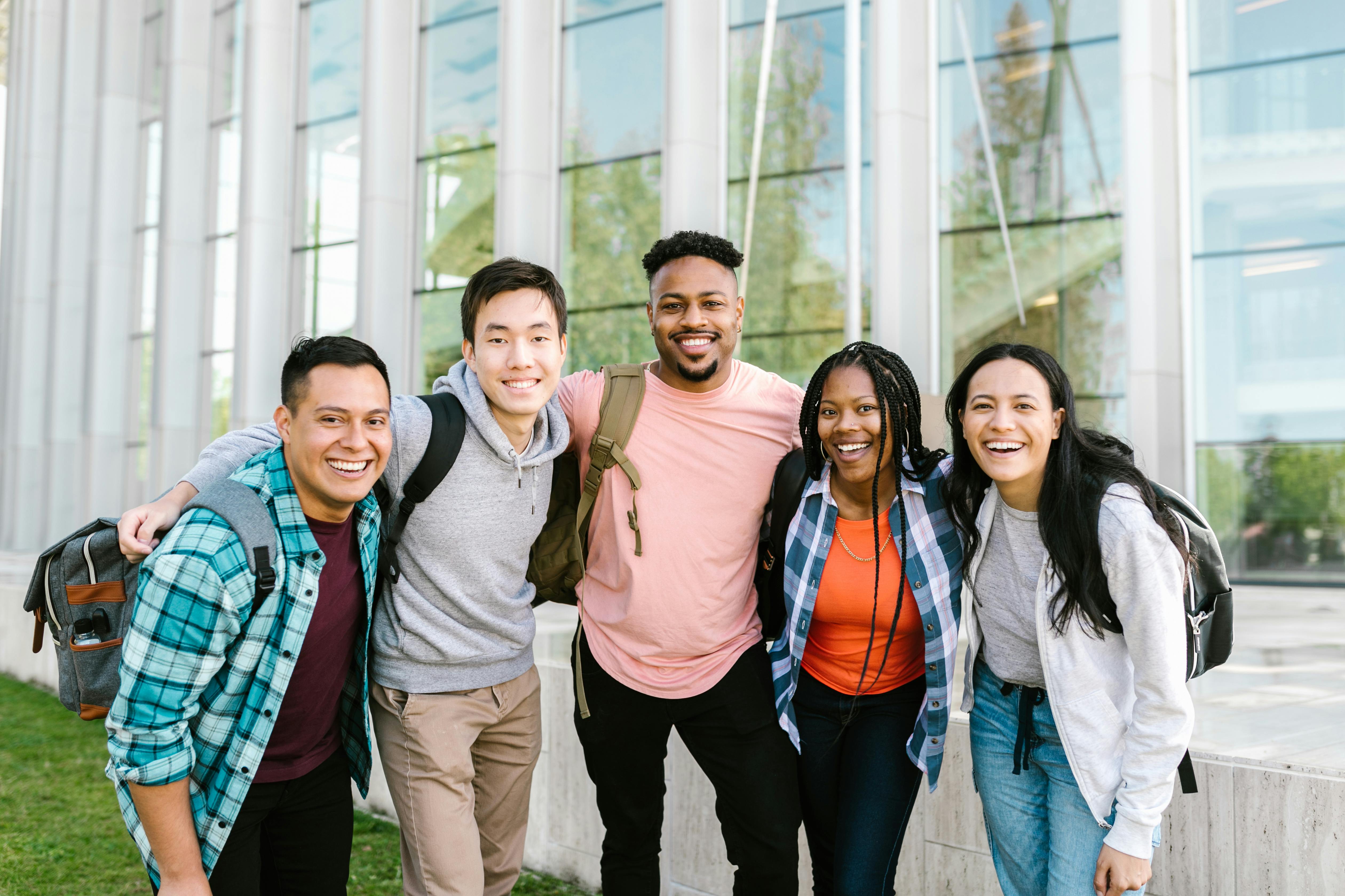 university students standing together outside a building