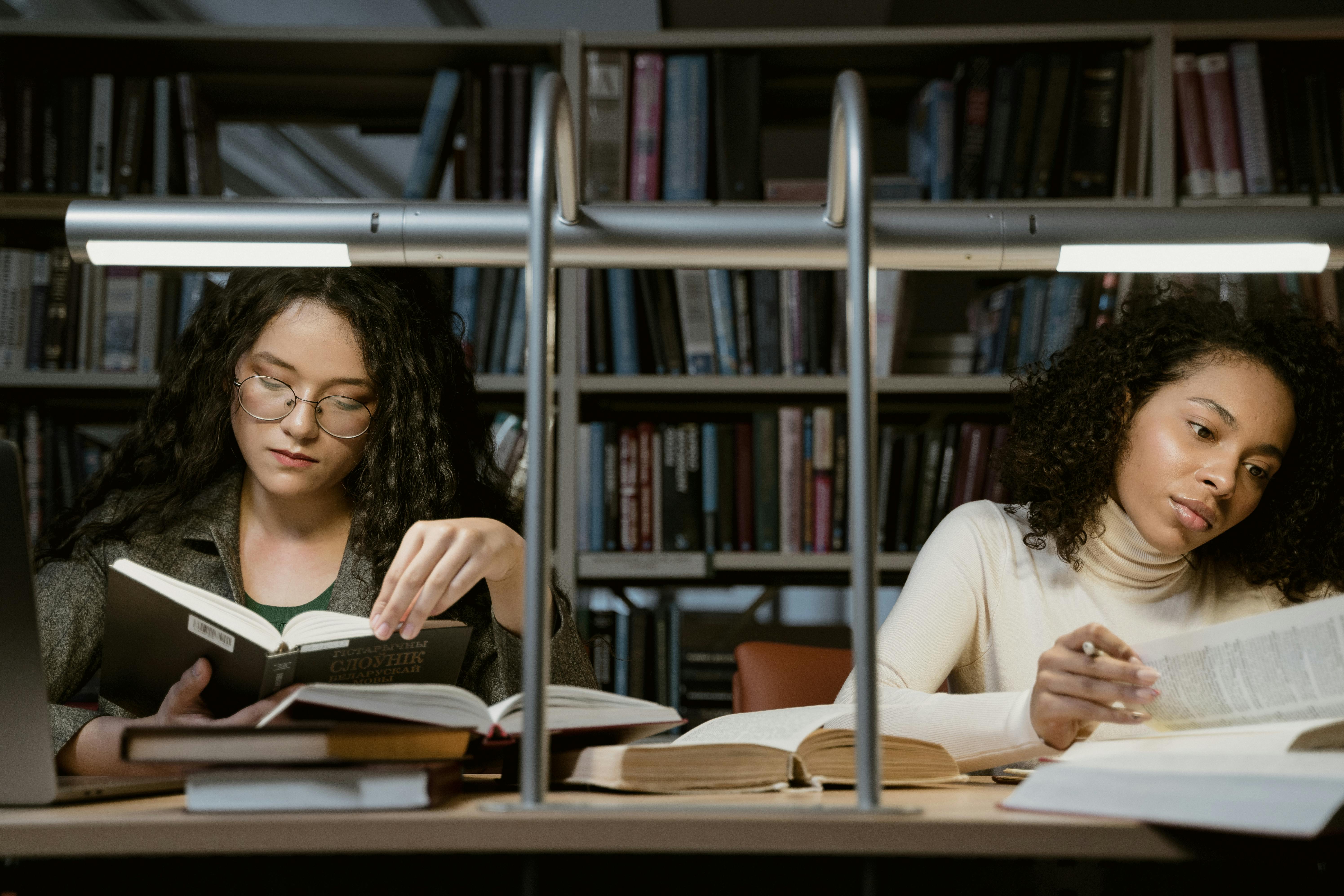 two female students studying in the library