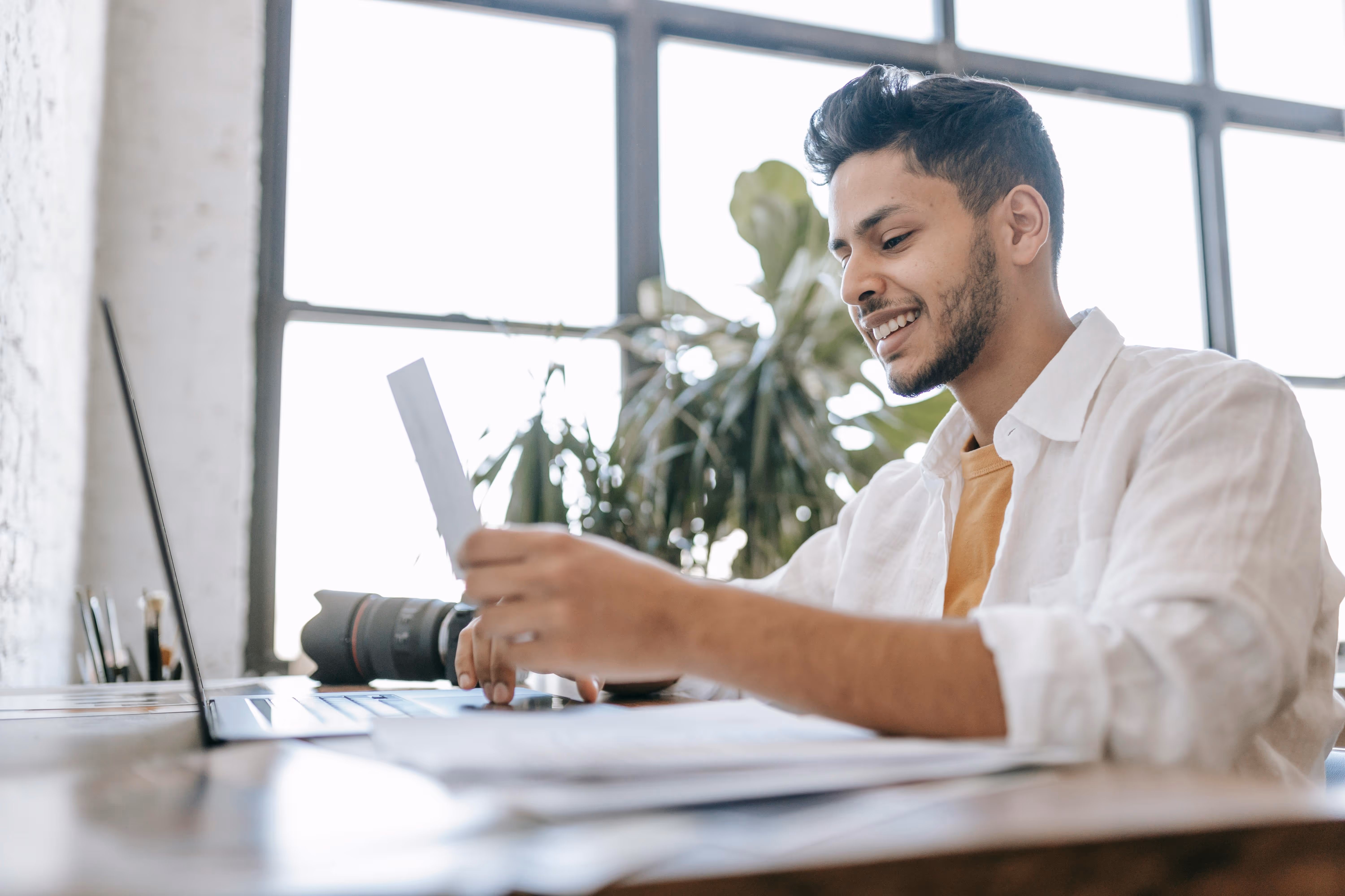 Smiling international professional working on a laptop