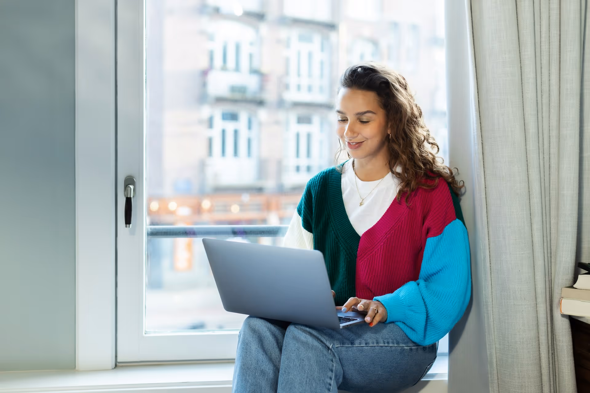 Smiling woman working on laptop