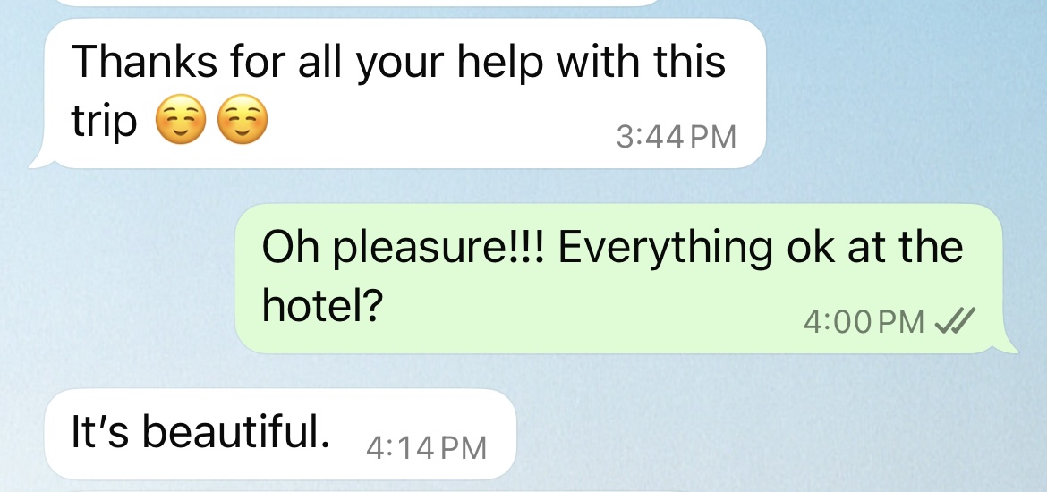 A text message conversation screenshot showing three messages. The first white bubble reads 'Thanks for all your help with this trip' followed by two smiling face emojis, timestamped at 3:44 PM. The second green bubble reads 'Oh pleasure!!! Everything ok at the hotel?' timestamped at 4:00 PM with read receipts. The third white bubble reads 'It's beautiful.' timestamped at 4:14 PM.