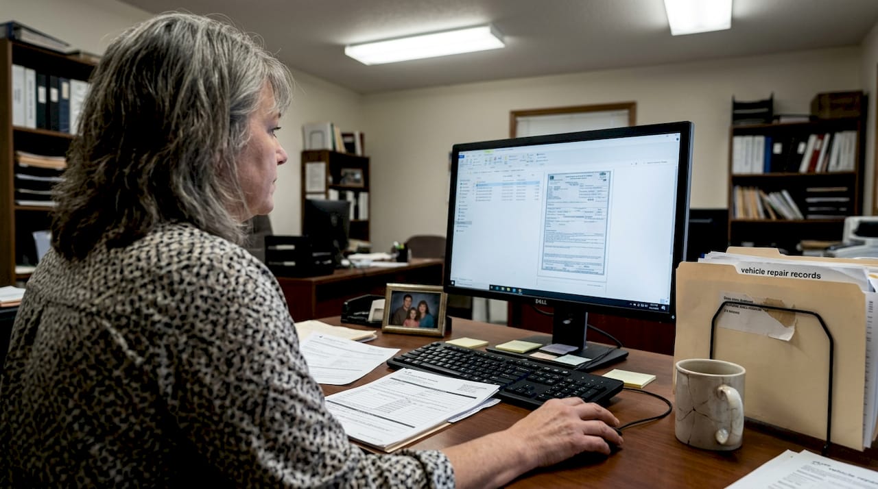 Insurance agent reviews vehicle title paperwork