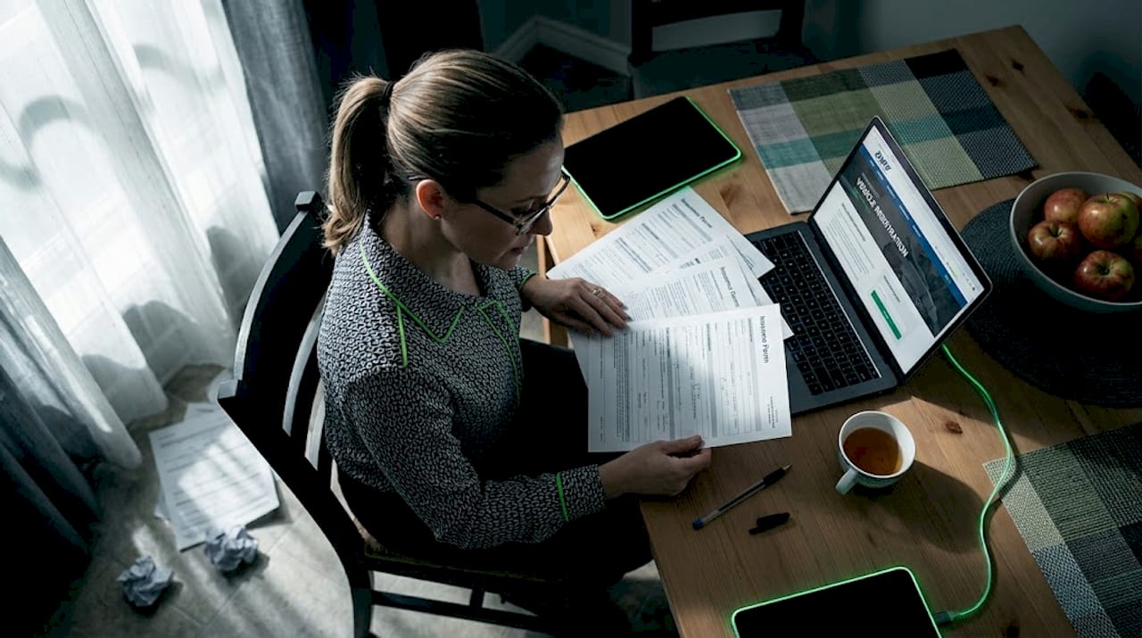 Woman sorting vehicle insurance paperwork