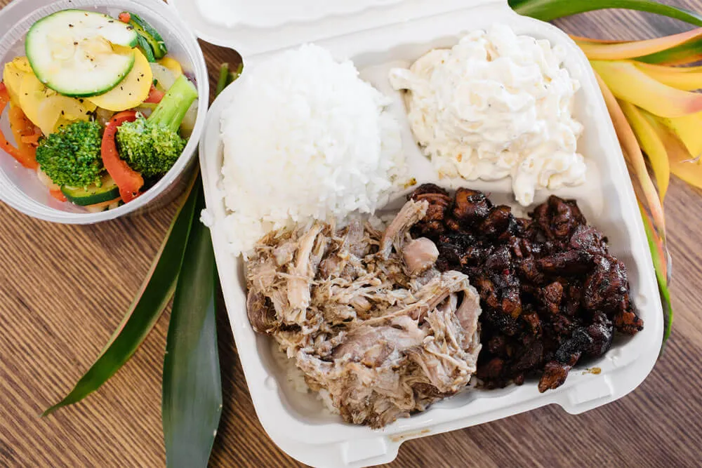 Hawaiian Bros mixed plate lunch with Luau Pig and chicken along with a side of vegetables.