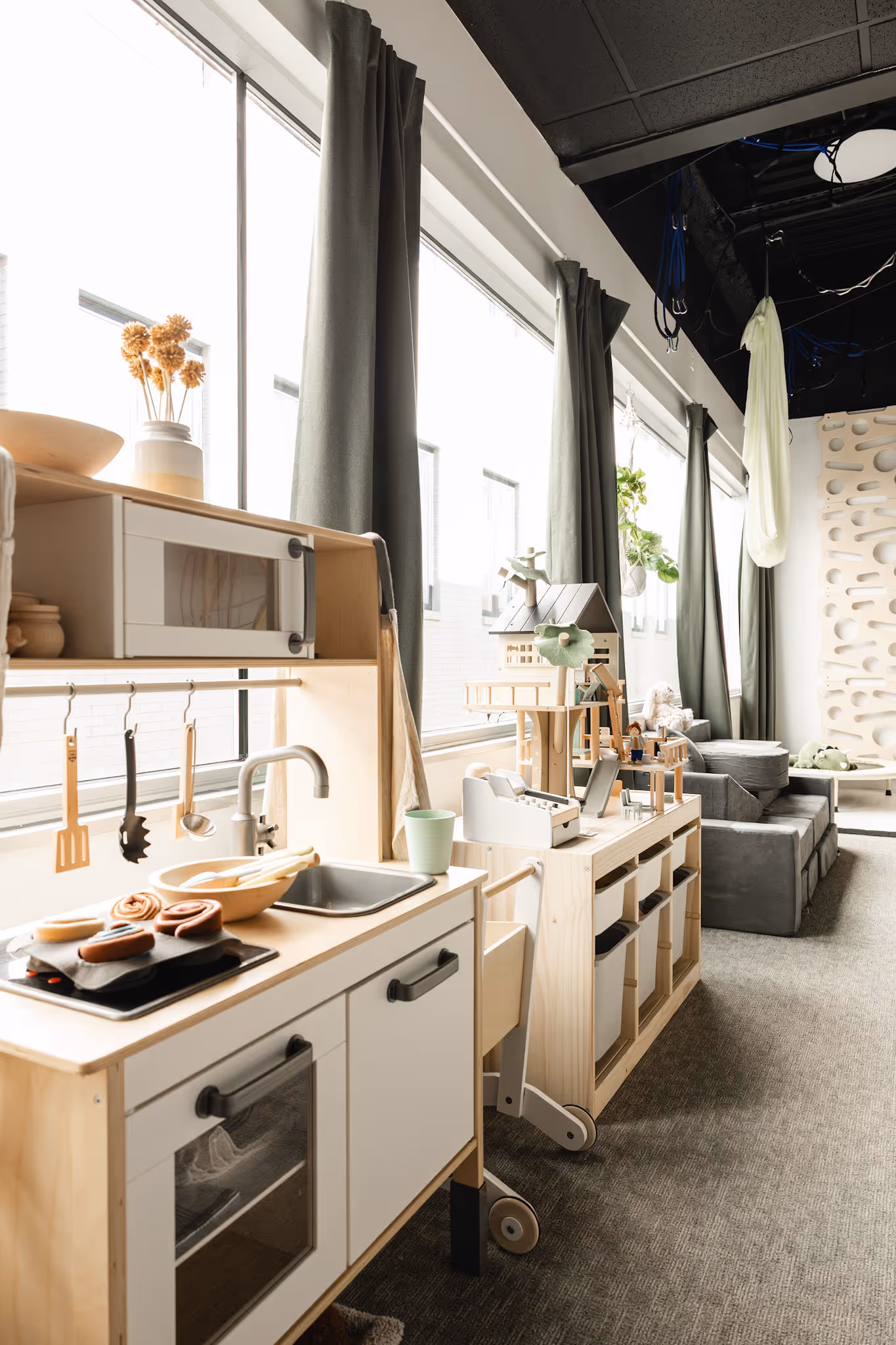 Child engaging with play kitchen during therapy session in Birmingham MI