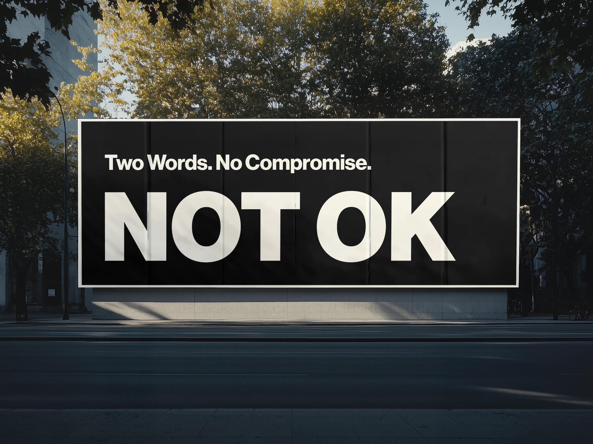 A black sign that says Two Words. No Compromise. NOT OK
