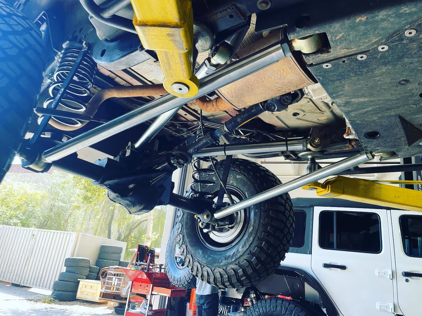 Underneath view of a lifted off-road vehicle with rugged suspension