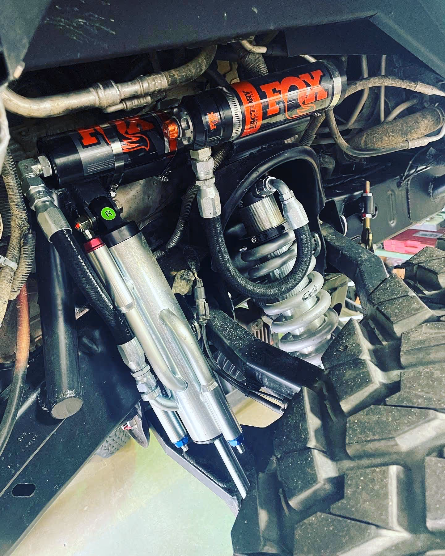 FOX suspension shock absorbers installed in a vehicle's engine compartment