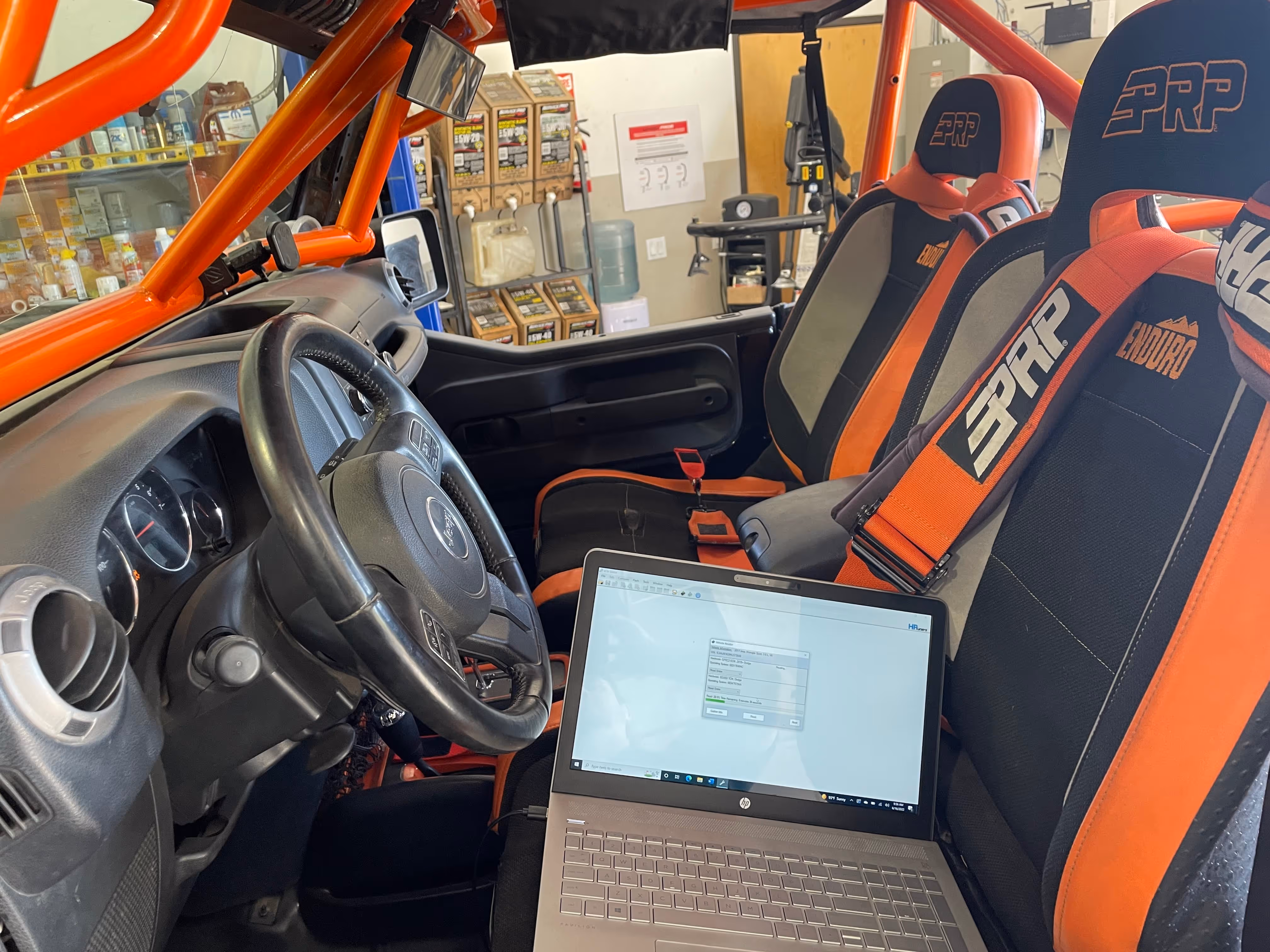 Orange off-road vehicle interior with laptop and racing seats