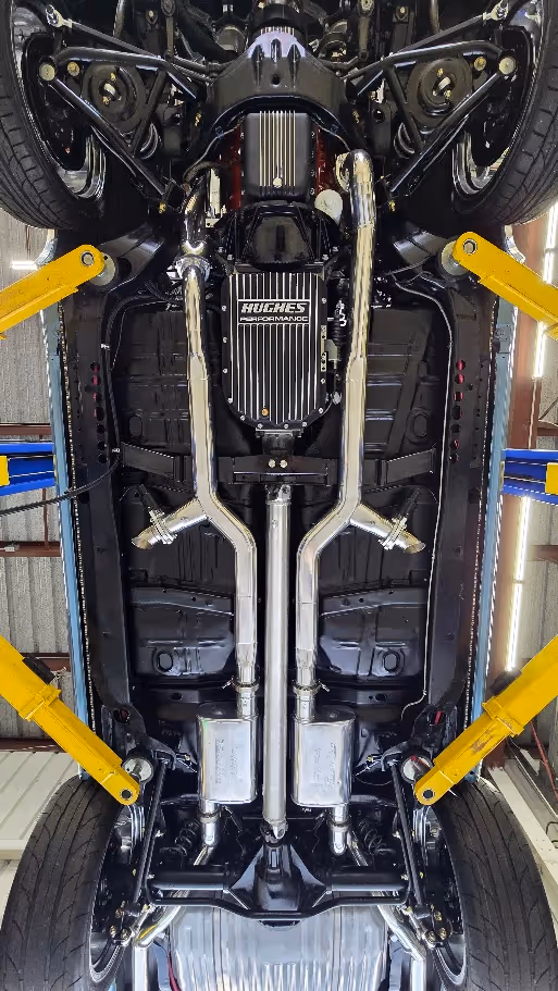 Undercarriage view of a car with complex suspension and exhaust system